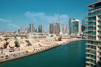 a view of a city with a river and buildings at Luxury Canal Front with Burj Khalifa Skyline View in Dubai