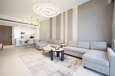 a living room with a couch and a table at Luxury Canal Front with Burj Khalifa Skyline View in Dubai