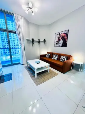 a living room with a couch and a table at Vibrant Marina Retreat! in Dubai