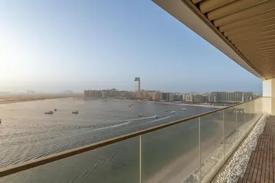 a view of the ocean from the balcony of a building at Grand Bleu I Private Beach I Palm Jumeirah, Sea & Sky Views I Infinity Pool I PS5 I by Skyline Serenity in Dubai