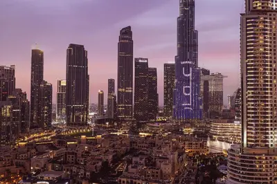 a city skyline at night with tall buildings at Lux apartment with full Burj View - 5 min walk to Dubai Mall in Dubai