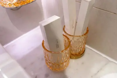 two orange vases sitting on a counter in a bathroom at Luxury Canal-View Studio in Dubai