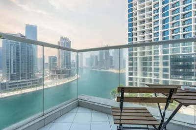 a balcony with a bench and a view of a river at Luxury Canal-View Studio in Dubai
