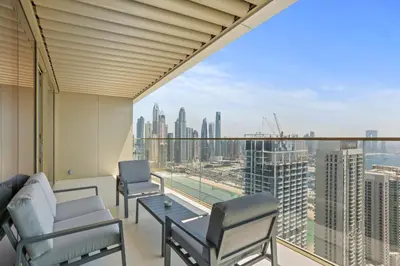 a balcony with chairs and a view of the city at Iconic 3 Bedroom with Panoramic View in Grand Bleu in Dubai