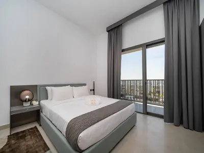 a bedroom with a large bed and a large window at Contemporary Meydan Studio Escape in Dubai