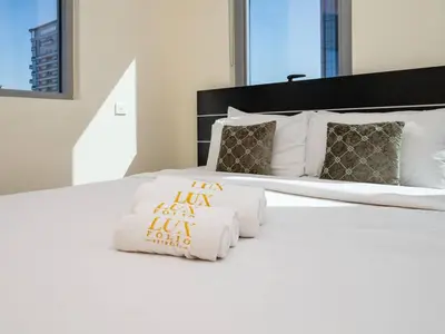 a white bed with towels and pillows on it at Spacious 3 Bed Marina Haven with Waterfront Views in Dubai
