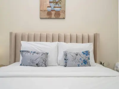 a bed with white sheets and pillows in a bedroom at Spacious 3 Bed Marina Haven with Waterfront Views in Dubai