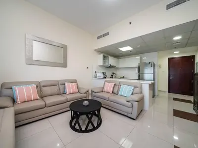 a living room with a couch and a table at Spacious 3 Bed Marina Haven with Waterfront Views in Dubai