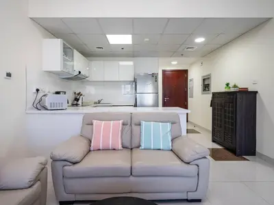 a living room with a couch with pillows on it at Spacious 3 Bed Marina Haven with Waterfront Views in Dubai