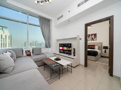 a living room with a couch and a bed at Elegant 1-Bedroom Retreat with Marina Views in Dubai