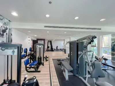 a gym with treadmills and machines in a room at Elegant 1-Bedroom Retreat with Marina Views in Dubai
