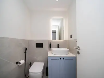 a bathroom with a white sink and a toilet at Luxurious 2 Bed Waterfront Living at Marina Quays in Dubai