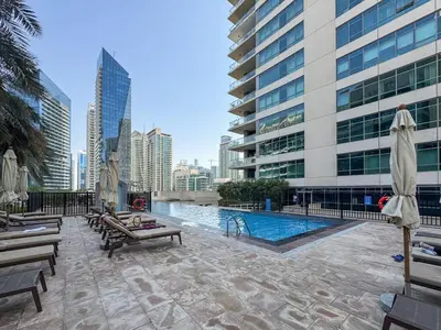 a pool in the middle of a city with buildings at Luxurious 2 Bed Waterfront Living at Marina Quays in Dubai