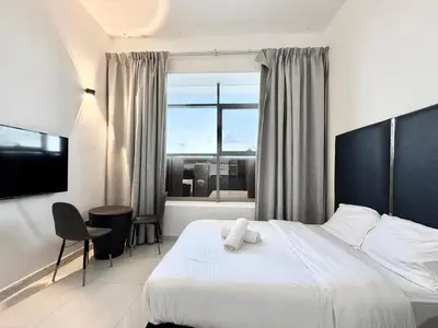 a hotel room with a bed and a window at Al Manara Classic Deluxe Sheikh Zayed Studio in Dubai