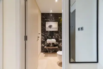a bathroom with a toilet and a sink at Best View Luxury 2BDR Palm Jumeirah, Beach & Pool in Dubai