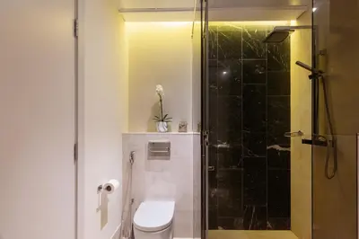 a bathroom with a toilet and a shower at Best View Luxury 2BDR Palm Jumeirah, Beach & Pool in Dubai