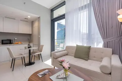 a living room with a couch and a table at Perfect Location-For Work or Leisure in Dubai
