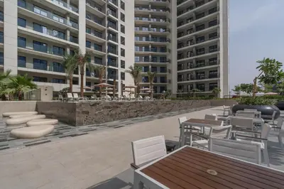 a patio with tables and chairs and buildings at Perfect Location-For Work or Leisure in Dubai