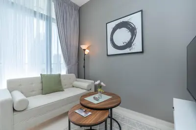 a living room with a white couch and a table at Perfect Location-For Work or Leisure in Dubai