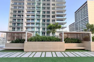 two benches in front of a tall building at PVH - Elegant 1BR in Binghatti House in Dubai