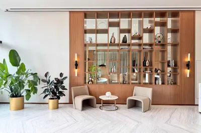a room with two chairs and a table and a shelf at PVH - Elegant 1BR in Binghatti House in Dubai