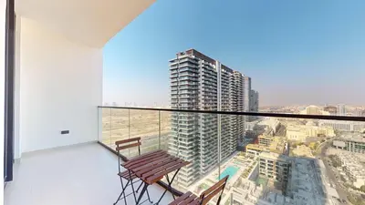 a balcony with two chairs and a view of a city at PVH - Stylish 1BR in Binghatti House in Dubai