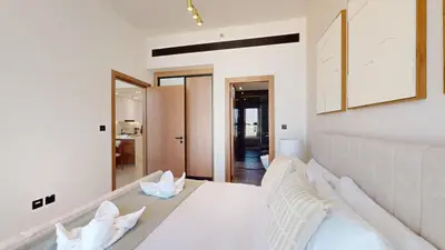 a white bedroom with a large bed with white pillows at PVH - Stylish 1BR in Binghatti House in Dubai