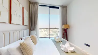 a living room with a couch and a large window at PVH - Stylish 1BR in Binghatti House in Dubai