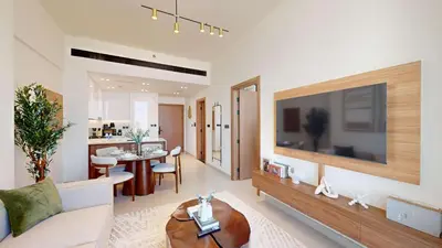 a living room with a large television and a dining room at PVH - Stylish 1BR in Binghatti House in Dubai