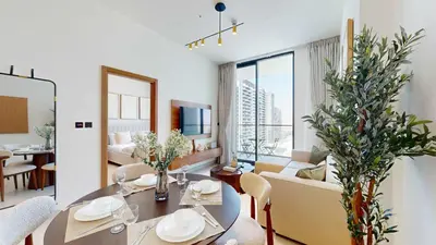 a living room with a table and a couch at PVH - Stylish 1BR in Binghatti House in Dubai