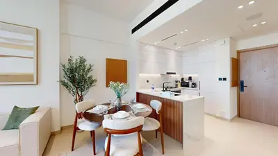 a kitchen and dining room with a table and chairs at PVH - Stylish 1BR in Binghatti House in Dubai