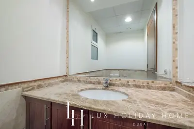 a bathroom with a sink in a room at LUX The Al Seef Marina Suite 2 in Dubai