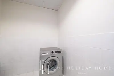 a washing machine in a bathroom with the words hwk holiday home at LUX The Al Seef Marina Suite 2 in Dubai
