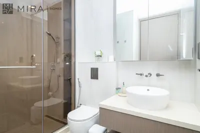 a bathroom with a sink and a toilet and a shower at Stylish 1BR in Peninsula Five Views & Pool in Dubai