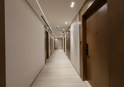 a corridor of a hallway with a long aisle at Brand New Luxurious 1 BR with Garden, Gym, Pool and Open View in Dubai