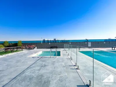 a swimming pool on a roof of a building at Cozy One-Bedroom in O2 Tower, JVC in Dubai