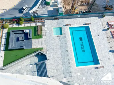 an overhead view of a swimming pool at Cozy One-Bedroom in O2 Tower, JVC in Dubai