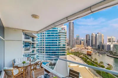 a balcony with chairs and a view of the city at Luxury Marina View with Jacuzzi, Arcade & Balcony in Dubai
