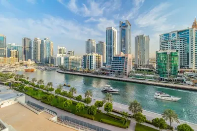 a view of a city with boats in a river at Luxury Marina View with Jacuzzi, Arcade & Balcony in Dubai