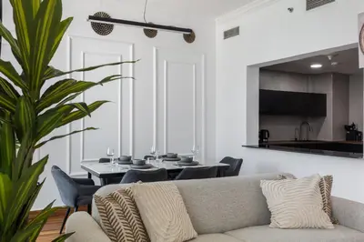 a living room with a couch and a table at Luxury Marina View with Jacuzzi, Arcade & Balcony in Dubai