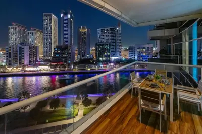 a balcony with a view of the city at night at Luxury Marina View with Jacuzzi, Arcade & Balcony in Dubai