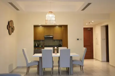 a dining room and kitchen with a table and chairs at Nivis find- Luxury & Spacious 1 BHK 10 mins away from Dubai mall in Dubai