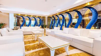 a waiting room with white couches and blue mirrors at Dubai Marina Modern 1 Bedroom Apartment - steps to tram & Marina Walk in Dubai