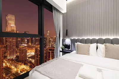 a bedroom with a view of a city at Mahogany 9 - 2BR 10PAX - Walk to Burj & Dubai Mall in Dubai