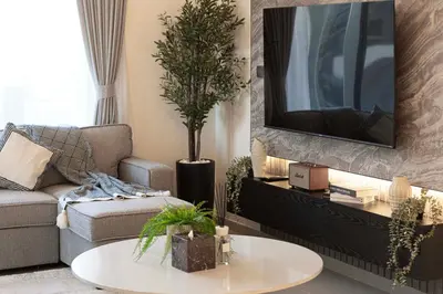 a living room with a couch and a tv at Mahogany 9 - 2BR 10PAX - Walk to Burj & Dubai Mall in Dubai