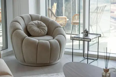 a living room with a chair and a table at Mahogany 3 - 2BR 6 Guests - Pool & Prime Location in Dubai