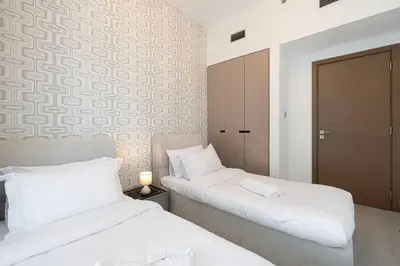 two beds sitting next to each other in a room at Mahogany 3 - 2BR 6 Guests - Pool & Prime Location in Dubai