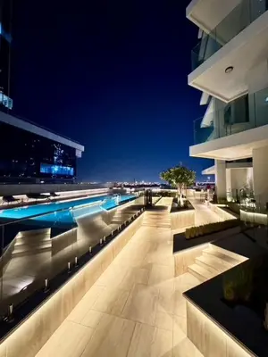 a building with a swimming pool at night at Mahogany 3 - 2BR 6 Guests - Pool & Prime Location in Dubai