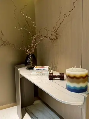 a table with a cake and books on it at Mahogany 3 - 2BR 6 Guests - Pool & Prime Location in Dubai