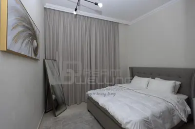 a bedroom with a bed and a large window at Downtown Dunya Tower in Dubai
